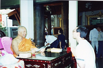 Paul donating to Somdet Chuang, the Abbot of Wat Paknam Bhasicharoen, Thailand